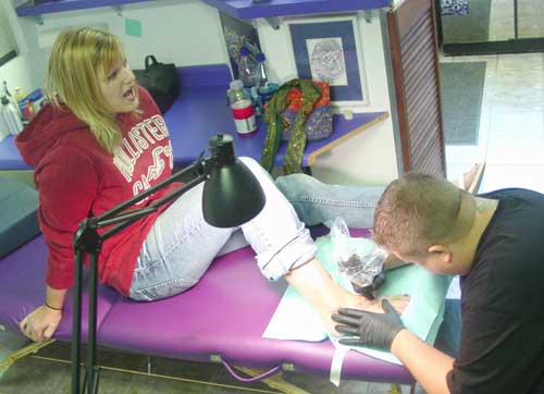 River Falls native Laura Richison gets a tattoo done by Jayson Graham of the 